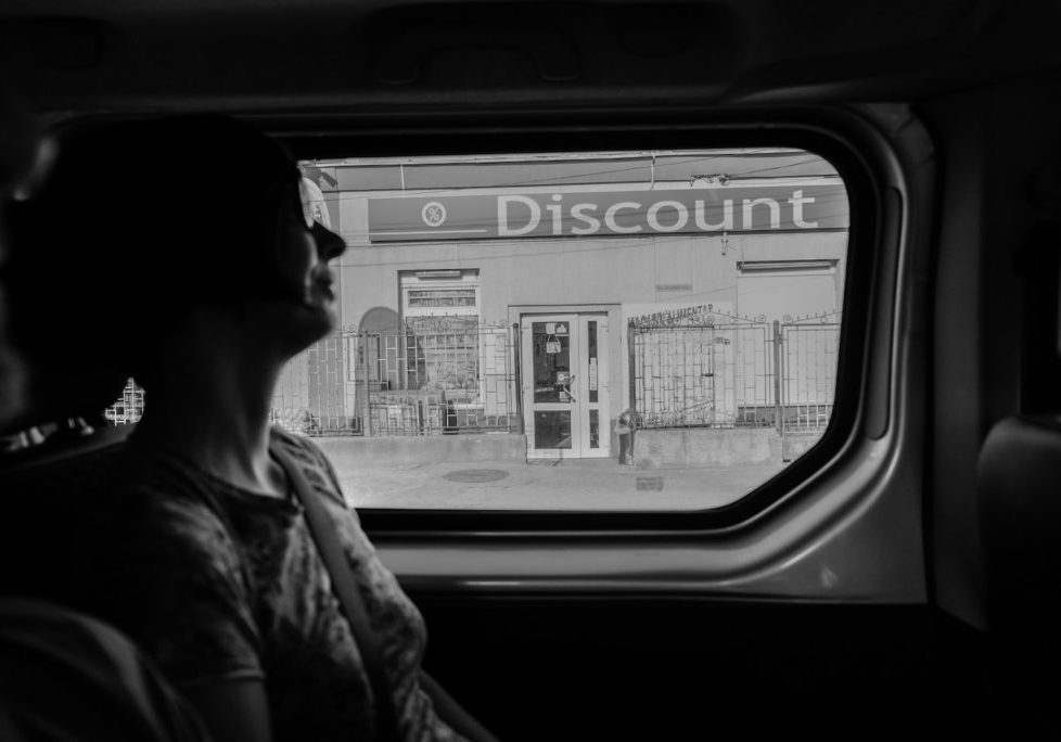greyscale photography of woman inside vehicle